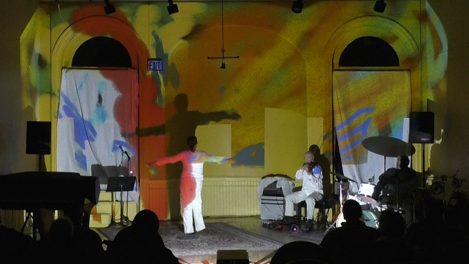 Patricia Nicholson - dance, Jason Kao Hwang - viola, Michael TA Thompson - drums on a colorful stage